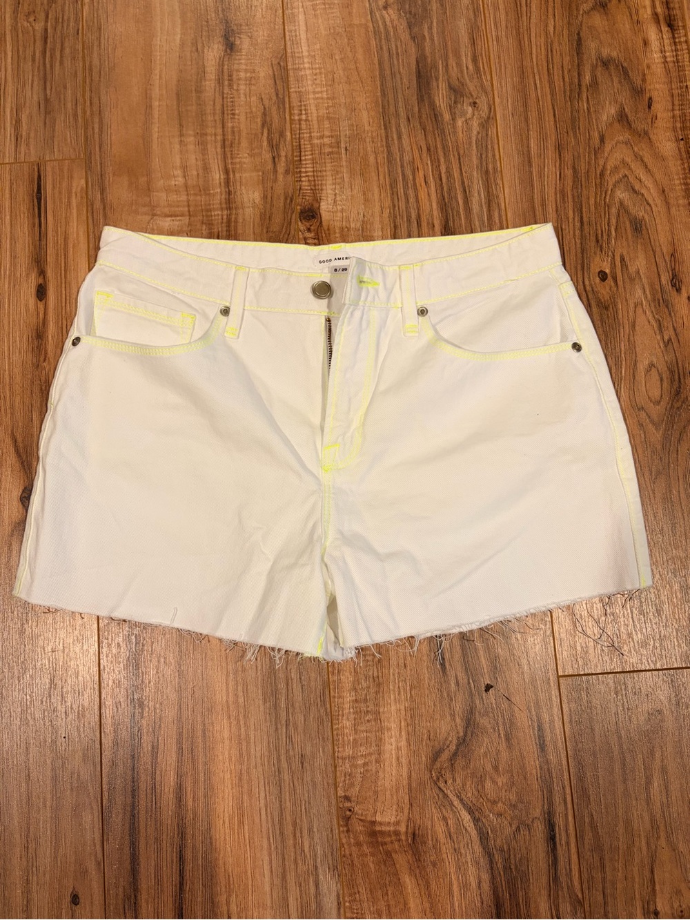 Good American White Denim Shorts with Neon Yellow Accents